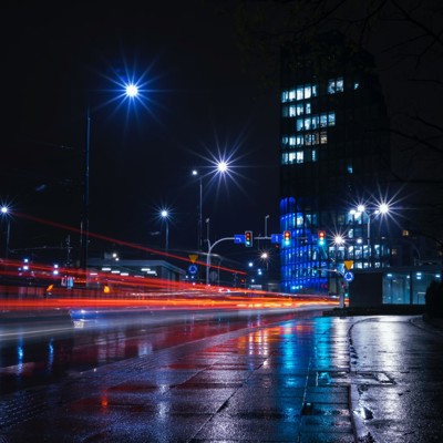 A dark cityscape with light trails